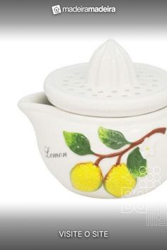 a ceramic tea pot with lemons painted on it