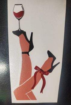 a paper cut out of a woman holding a glass of wine