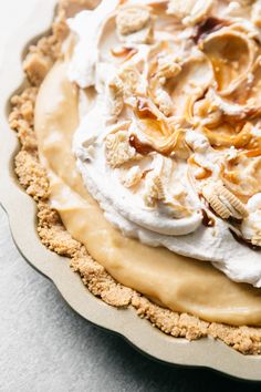 a pie topped with whipped cream and nuts