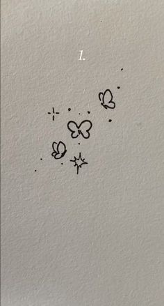 some black ink on white paper with butterflies and stars in the middle, one is drawn by hand