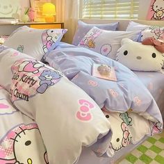 a bed with hello kitty sheets and pillows