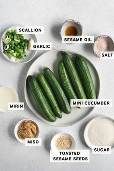 cucumbers are arranged on a white plate with ingredients labeled in the following words