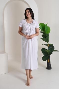 The perfect blend of comfort and charm with our cotton poplin nightgown, featuring short sleeves and a beautifully crafted lace trim neckline. Made from crisp, breathable cotton poplin, this nightgown offers a soft touch against the skin, ensuring a comfortable fit for warm nights. The short sleeves provide a relaxed yet polished look, while the elegant lace trim at the neckline adds a delicate, feminine touch. Falling gracefully to mid-calf, this nightgown showcases a flattering silhouette that White Cotton Home Dress, White Cotton Dress For Home, White Cotton Dress For Loungewear, White Cotton Short Sleeve Nightgown, White Summer Nightgown For Hospital, White Relaxed Fit Nightgown For Sleep, Spring White Cotton Nightgown, White Cotton Nightgown Relaxed Fit, White Short Sleeve Nightgown For Bedtime