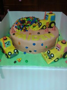 a birthday cake decorated with cars and candy