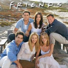 the cast of friends posing for a photo on the beach in front of some chairs