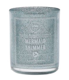 a candle that is sitting on top of a white surface with the words mermaid shimmer written