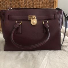 Michael Kors Burgundy Purse. In Good Condition, Has Slight Lipstick Stains On The Inside Zipper Pocket (Pictured) But Overall Good Condition. Crossbody Strap Included And Light Wear Throughout. Burgundy Leather Bag With Branded Hardware, Burgundy Top Handle Shoulder Bag With Branded Hardware, Formal Burgundy Bags With Branded Hardware, Burgundy Satchel With Gold-tone Hardware, Burgundy Bag With Branded Hardware, Burgundy Bags With Branded Hardware For Daily Use, Classic Burgundy Bags With Gold-tone Hardware, Burgundy Travel Bags With Gold-tone Hardware, Michael Kors Burgundy Bags With Branded Hardware