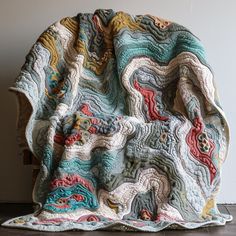 a blanket that is sitting on top of a chair next to a wall and floor