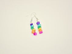 Embrace your inner free spirit with these bright dainty colorful stone dangle earrings.  Bold, colorful, and lightweight. Featuring a single strand of bright colorful glass stone beads. *Handcrafted glass stone earrings. Uniquely made and one of a kind. *Bright silver hooks * Perfect for a fancy outfit or a casual day out * Earrings ship safely on earring holder, in a small bag, in a padded envelope * Perfect for a gift for someone special or for yourself! Multicolor Earrings With Gemstone Accents, Perfect As A Gift, Multicolor Hand-strung Dangle Earrings, Multicolor Multi-stone Dangle Earrings, Purple Multi-stone Dangle Earrings, Stone Dangle Earrings, Earring Holder, Fancy Outfits, Free Spirit, Small Bag