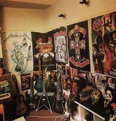 a room filled with guitars and posters on the wall