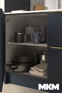 an open cabinet with pots and pans on it