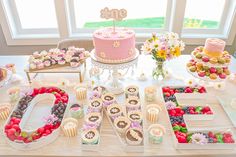 a table topped with lots of cakes and desserts