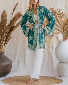 Our Aphrodite Short Kimono, made from soft viscose double gauze fabric, offers a luxurious feel and an ethereal appearance. Designed to enhance your presence in any setting, its flowing silhouette and lightweight, breathable fabric ensure a graceful and comfortable fit. Ideal for lounging by the pool or attending special events, this piece is perfect for making a statement. Its versatile design provides multiple styling options, making it an indispensable addition to your wardrobe. Celebrate your divine beauty and radiate grace with our reversible Short Kimono. Elegant Long Sleeve Sleepwear For Vacation, Chic Long Sleeve Kimono For Loungewear, Viscose Sleepwear For Summer, Casual Relaxed Fit Kimono For Loungewear, Chic Flowy Kimono For Loungewear, Rayon Kimono For Loungewear, Flowy Long Sleeve Kimono For Loungewear, Long Sleeve Rayon Kimono, Casual Relaxed Fit Kimono