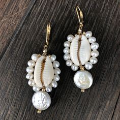 Tiny faux pearl trimmed cowry shells with freshwater coin pearl drop. Gold filled lever back 2” drop Summer Pearl Drop Earrings, Shell-shaped Pearl Earrings With Pearl Charm, Elegant White Cowrie Shell Jewelry, Pearl Shell Earrings With Pearl Charm, Pearl Drop Shell-shaped Earrings In Mother Of Pearl, Summer Pearl Drop Dangle Earrings, Beach Pearl Drop Earrings, Shell-shaped Pearl Drop Earrings, Elegant Pearl Charm Earrings With Shell