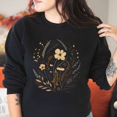 Introducing our delightful floral sweater, the perfect blend of style and comfort. Made from high-quality, soft materials, this sweater features a stunning floral design that adds a touch of elegance to any outfit. Whether you dress it up with a skirt or pair it with jeans for a casual day out, this versatile sweater will keep you cozy and chic all year long. With its flattering fit and eye-catching pattern, it's sure to become a favorite in your wardrobe. Step into the season with confidence and make a statement with our beautiful floral sweater. .: 50% cotton, 50% polyester .: Medium-heavy fabric (8.0 oz/yd² (271.25 g/m .: Loose fit .: Sewn-in label .: Runs true to size Floral Print Sweater For Fall, Cozy Long Sleeve Sweater With Floral Print, Fall Cotton Sweater With Floral Print, Fall Cotton Floral Print Sweater, Cotton Floral Print Fall Sweater, Cotton Floral Print Sweater For Fall, Cotton Floral Print Long Sleeve Sweater, Floral Print Long Sleeve Sweatshirt For Fall, Fall Floral Print Crew Neck Sweater