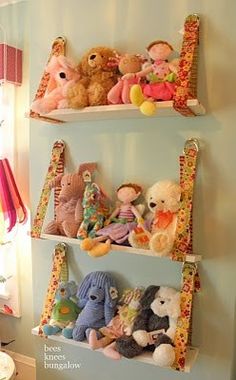 three shelves filled with stuffed animals on top of each other in a child's room