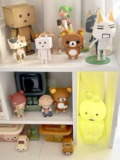 some little figurines sitting on top of a shelf