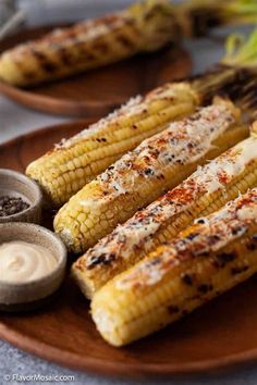 grilled corn on the cob with butter and seasoning sitting on a plate