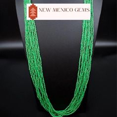 This is a multi strand green glass seed bead necklace. Southwestern glass green seed bead necklace. Dress it up or down. Great for the office.  *10 strands of glass seed beads *Adjustable length on this beauty up to 33". Has a lobster clasp. *Gift boxes available. All jewelry also comes in a nice box.  *Check out the rest of our collection: https://www.etsy.com/shop/NewMexicoGems Thank you for your business. We appreciate you. Multi-strand Green Large Beads, Green Southwestern Jewelry With Spacer Beads, Southwestern Green Jewelry With Spacer Beads, Southwestern Style Green Jewelry With Spacer Beads, Green Multi-strand Beaded Necklaces With Large Beads, Green Multi-strand Jewelry With Tiny Beads, Green Multi-strand Beaded Necklace With Large Beads, Green Multi-strand Beaded Jewelry, Green Multi-strand Necklace With Tiny Beads