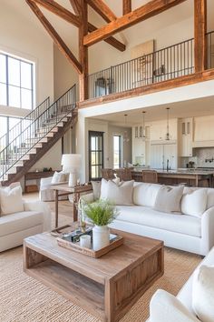 a living room filled with furniture and a stair case in front of the couches