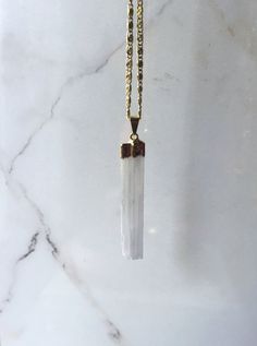 This listing is for one Selenite Crystal Blade pendant. This selenite crystal is plated in 18kt gold and the chain is stainless steel plated in 18kt gold and does not tarnish. About Selenite: Among one of the most protective stones, Selenite is powerfully shielding. Selenite brings a strong sense of peace and tranquility to anyone wearing/using it. It's also amazing at clearing energy. White Mineral Crystal Pendant Necklaces, White Quartz Pendant Necklace, White Gemstone Jewelry With Mineral Crystal, White Mineral Crystal Spiritual Necklaces, White Mineral Crystal Jewelry For Healing, White Quartz Pendant Jewelry, White Quartz Necklace For Gift, Handmade White Quartz Jewelry, Spiritual White Quartz Necklaces