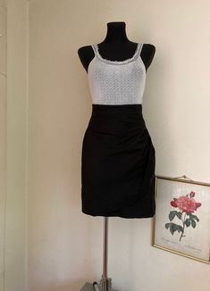 "♥ Vintage high waist pencil skirt in basic black, perfect for office or an outing in a city with that long oversized blazer coat. ♥ Very elegant and timeless piece. ♥ Fixed envelope detail in front, banded waistline with pleating. Looks like the skirt hem was folded to make it shorter, so if you wish, you can undo it and make the skirt longer by approx. 8 cm (knee length). ♥ Pure silk fabric.  ♥ Fully lined, closes with a zipper and hook. ♥ Good vintage condition with minor signs of fabric wear Fitted Mini Skirt For Office Party, Fitted Office Lady Mini Skirt For Party, Elegant Mini Pencil Skirt For Summer, Elegant Summer Mini Pencil Skirt, Elegant Mini Length Summer Pencil Skirt, Fitted Black Mini Skirt For Office, Black Fitted Mini Skirt For Office, Elegant Pencil Skirt Style Skort For Party, Elegant Black Mini Pencil Skirt