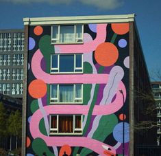 a large building painted with colorful designs on it's side