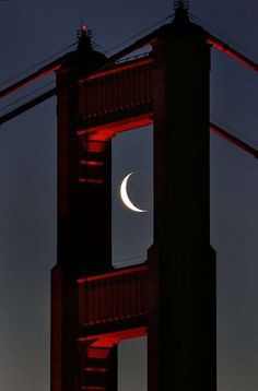 the crescent moon is seen over the golden gate bridge in san francisco, calif