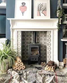 a living room with a fire place and pictures on the wall