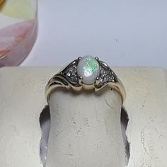 This Pretty Estate Ring Features A Natural 7x5mm Oval Precious Opal, Set With 4 Secure Yellow Gold Prongs In The Center. On Both Sides Are What Appears To Be A Split Shank With 3 Natural Small White Diamonds Set Down In, 6 In All, & Prong Set. The Ring Measures Aprox 1/4" In Width At The Top Center, And Weighs Aprox 2.429 Grams Of Solid (Stamped 10kt & Clein Inside Shank) 10kt Yellow Gold. This Pretty Opal And Diamond Estate Ring Is Priced In Our Store At $2999.00. Finger Size 6 (This Ring Can Be Sized By Your Local Jeweler, At Your Cost, We Do Not Size, Sorry) *All Of Our Vintage And Estate Jewelry Is Sold As Is And Has Been Checked For Security On Gems By Ceres, And Or Gold/925 Purity, An Oval Opal Ring In 14k Gold, Hallmarked, Antique Oval Multi-stone Opal Ring, Victorian Yellow Gold Opal Cabochon Ring, Jewlery Rings, Adjustable Opal Crystal Ring, Oval Shape, Antique 14k Gold Opal Ring, Oval Cabochon, Estate Rings, Precious Opal, Womens Jewelry Rings