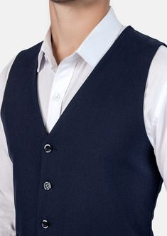 This Navy Blue Vest is designed with stretch cotton for comfort, and features a classic, vibrant navy blue color that is timeless in style. Its versatility allows you to level up any outfit, making it a must-have wardrobe staple. Classic Blue Cotton Outerwear, Formal Navy Cotton Outerwear, Elegant Blue Cotton Outerwear, Classic Navy Business Tops, Classic Navy Tops For Business, Classic Fitted Navy Outerwear, Classic Navy Fitted Outerwear, Navy Fitted Semi-formal Top, Classic Navy Cotton Outerwear