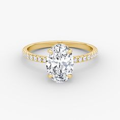 an oval cut diamond engagement ring set in yellow gold