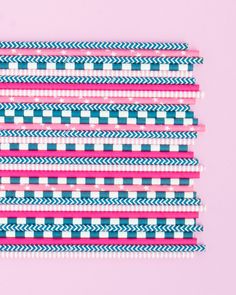 pink, blue and white straws on a pink background