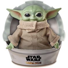 the child yoda doll is sitting in a bowl