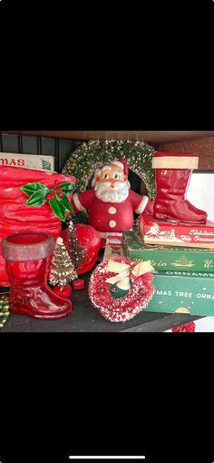 a table topped with lots of christmas decorations and books on top of eachother