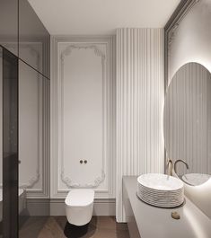 a modern bathroom with white walls and wood flooring, along with a round mirror on the wall