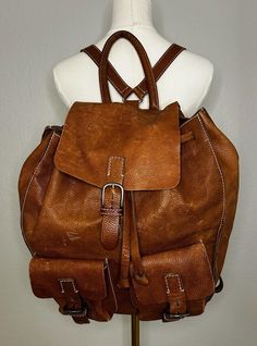 Discover the charm of this vintage Eddie Bauer leather backpack. Made in Portugal, it features sturdy brown leather, comfortable adjustable straps, and convenient internal pockets. Perfect for daily use or outdoor adventures, this backpack blends functionality with a timeless style. Vintage Leather Backpack For Daily Use, Vintage Backpack With Leather Backing, Vintage Brown Leather Satchel Backpack For Travel, Vintage Leather Adventure Backpack, Vintage Brown Backpack With Leather Lining, Vintage Leather Travel Backpack, Vintage Leather Backpack For Adventure, Brown Vintage Backpack With Leather Lining, Brown Vintage Leather Backpack