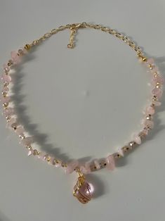 ♡ The materials that are used for our hand made necklaces are , rose quartz gemstone , crystals, gold plated apparatus and at the end of necklaces are made by zircon stones. ♡ To extend its lifespan, do not contact it with chemical products like perfumes ,moisturizers etc. Do not pull or tug on the necklace. Rose Quartz Chips Necklace, Rose Quartz Beaded Necklace, Rose Quartz Jewelry Necklaces, Gold Rose Quartz Pendant Jewelry, Gold Rose Quartz Jewelry For Jewelry Making, Gold Rose Quartz Gemstone Jewelry, Elegant Quartz Jewelry With Gemstone Beads, Rose Quartz Gemstone Gold Jewelry, Gold Jewelry With Rose Quartz Gemstone