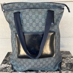 Authentic Gucci Tote Black/Gray Classic Gg Web Monogram Canvas Large Leather Pocket In Front Zip Closure In Great Vintage Condition Overall. Refer To Images For Visual Condition Excellent Condition On The Inside And Very Clean Minor Rubbing On Back Of The Bag, Leather Pocket And Corners Minor Wear On Handles Missing Leather Zipper Pull On Front Pocket - Can Still Be Opened By Metal Hardware Pull Made In Italy Approximate Measurements: 12” (L) X 6” (W) X 15” (H) 8” Drop See Photos For Overall Con Hardware Pulls, Gucci Tote, Leather Pocket, Gucci Black, Leather Zipper, Metal Hardware, Monogram Canvas, Womens Tote Bags, Gucci Bag