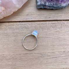 💙Opalite Wire Wrapped Ring - 1 Ring💙 This ring features a small (6mm) opalite stone bead, wrapped in your choice of wire. The options are silver plated, copper, bronze, black, or gold colored wire. All except the silver plated have a non tarnish coating so they will never oxidize or change color. Being careful to not wear your rings while showering or washing your hands a lot will make the silver rings last longer. Pease keep in mind that these are made to order, and the stone color may vary s Adjustable Silver Opal Ring For Healing, Adjustable Sterling Silver Opal Ring For Healing, Handmade Adjustable Opal Ring For Healing, Adjustable Moonstone Healing Ring, Adjustable Moonstone Ring For Healing, Adjustable Nickel-free Moonstone Promise Ring, Adjustable Blue Opal Ring, Adjustable Opal Ring For Healing, Adjustable Opal Ring For Spiritual Healing