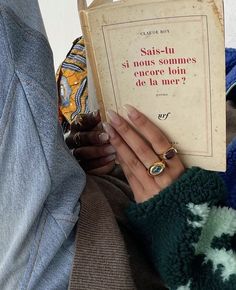 a woman is holding a book in her hands