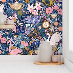 the wallpaper in this room is colorful and has many flowers on it, as well as vases