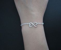 "♥ Sterling silver chain & clasp ♥ Double chained bracelet ♥ 12x21mm LARGE sterling silver infinite heart charm ♥ 9x16mm SMALL sterling silver infinite heart charm ♥ Solid sterling silver components ♥ Simple and elegant ♥ Bracelet size is the TOTAL length, which includes the spring clasp and the jump ring ♥ Petite bracelet size is 6 1/2\"; Standard bracelet size is 7\" ♥ Bracelet size guide: measure your wrist just below the wrist bone to get the wrist size ✤ For a smug fit (tighter) bracele Silver Infinity Heart Bracelet As Gift, Sterling Silver Infinity Bracelet For Valentine's Day, Elegant Sterling Silver Heart Bracelet For Friendship, Elegant Silver Heart Bracelet For Friendship, Valentine's Day Sterling Silver Infinity Bracelet, Valentine's Day Infinity Sterling Silver Bracelet, Silver Infinity Heart Bracelet For Valentine's Day, Silver Heart Bracelet In Sterling Silver, Sterling Silver Infinity Heart Bracelet