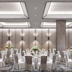 a banquet room set up with white linens and tables