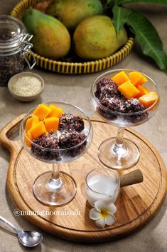 two dessert dishes with fruit in them on a wooden tray