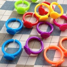 several pairs of colorful plastic rings on a checkered tablecloth