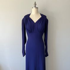 "This stunning vintage purple gown is in great condition! Only one small flow which is a little tear in the fabric on the right hand side of leg. See image. I will patch it up from the inside so will be hardly noticeable. This would make an amazing dress for a photo shoot or an evening event or party! This dress is longer in the back giving it a mini train. It's a very high end elegant gown! Size: S Tag - none Era - 30s Material - rayon, fabric covered metal buttons Bust - 34\" Waist - 27\" Hips Vintage Long Sleeve Evening Dress, Formal Fitted Vintage Dress, Vintage Long Sleeve Evening Dress For Formal Occasions, Vintage V-neck Evening Dress For Formal Occasions, Vintage Solid Color Formal Dress, Vintage Blue Evening Dress, Vintage V-neck Evening Dress, Vintage Purple Party Dress, Purple Retro Formal Dress