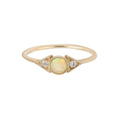 Our Opal Spear Ring features a soft Australian opal, but set in our Spear setting, this piece feels just a touch edgy.  We love the variety of color in opals and our signature milgrain texture gives this lovely piece just a hint of nostalgia. Details: - 4 mm Australian opal - two 1.8 mm diamonds - milgrain detail Avail Classic Ethiopian Opal Gemstone Rings, Elegant Ethiopian Opal Cabochon Rings, Opal Rings With Gemstone Accents, Heirloom Ethiopian Opal Round Ring, Fine Jewelry Opal And Moonstone Multi-stone Ring, Opal And Moonstone Multi-stone Fine Jewelry Ring, Heirloom Opal Jewelry In Round Shape, Yellow Gold Opal Birthstone Ring, Wedding Multi-stone Ring With Ethiopian Opal