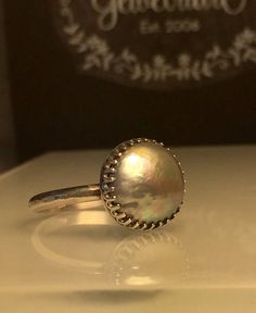 Silver Pearl ring. Grey Pearl Ring. Solitare Pearl Ring. Round Pearl Ring. Modern Pearl Ring. Girlfriend gift. Beautifully Handcrafted upcycled bezel set Natural Cultured Pearl set on a lightly hammered solid sterling silver band.. This unique yet very versatile ring is a size 9 1/2 but is available in any size with a very similar Pearl and is sure to be your go to accessory for all your fresh spring looks. ❤️❤️Give the thoughtful gift of handcrafted. ❤️❤️ Great bridesmaid gift! Will dis... Silver Dome Ring With Round Band As Gift, Silver Dome Ring As Gift, Silver Dome Ring Gift, Unique Pearl Promise Ring, Round Dome Ring With Gemstone As Gift, Silver Stackable Dome Ring Gift, Handmade Opal Toe Ring As Gift, Iridescent Ring Jewelry For Anniversary, Iridescent Sterling Silver Rings For Gifts