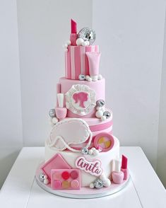 a three tiered cake with pink and white decorations on it's sides,